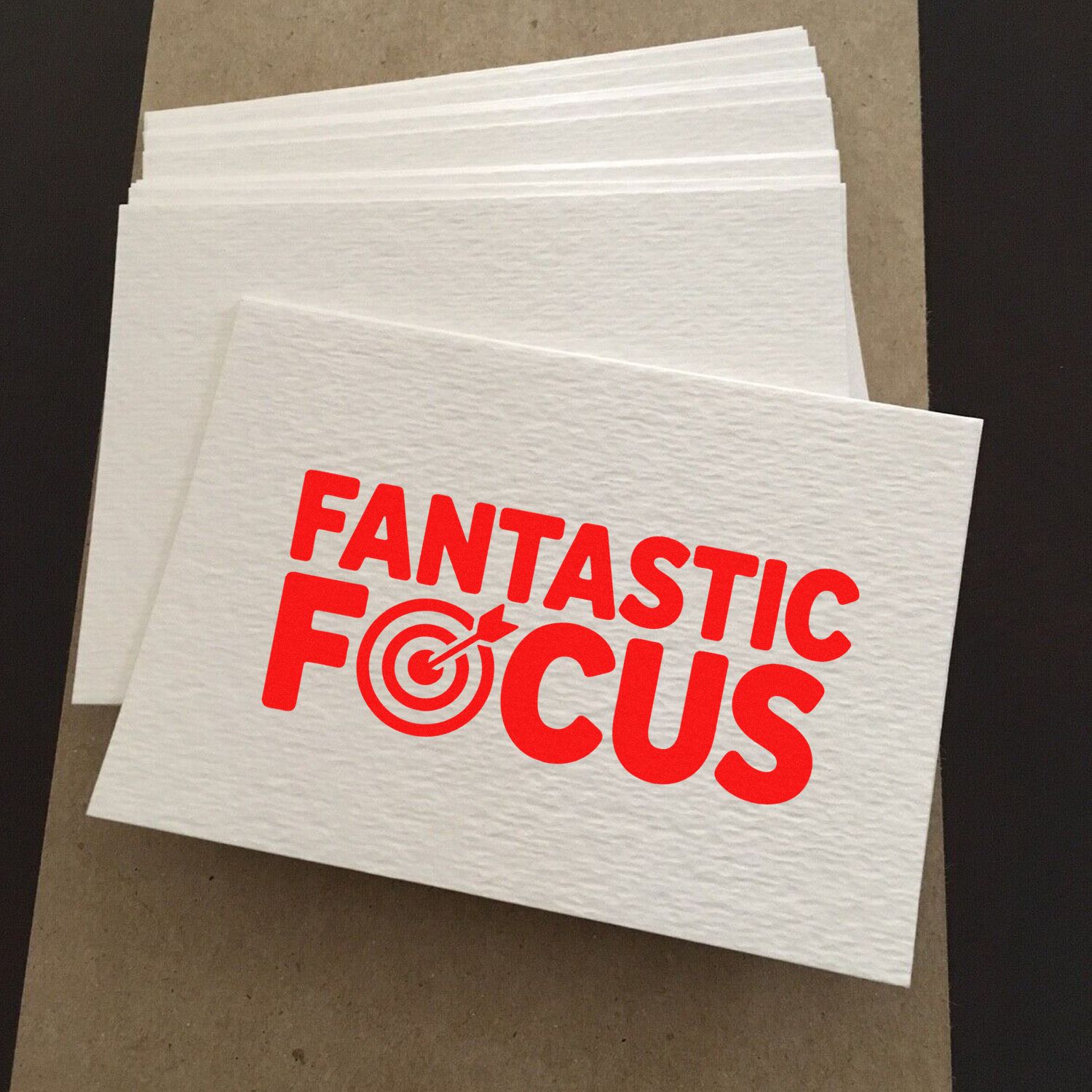 Custom rubber stamp logo on white napkins featuring red Fantastic Focus target design for branded promotions.