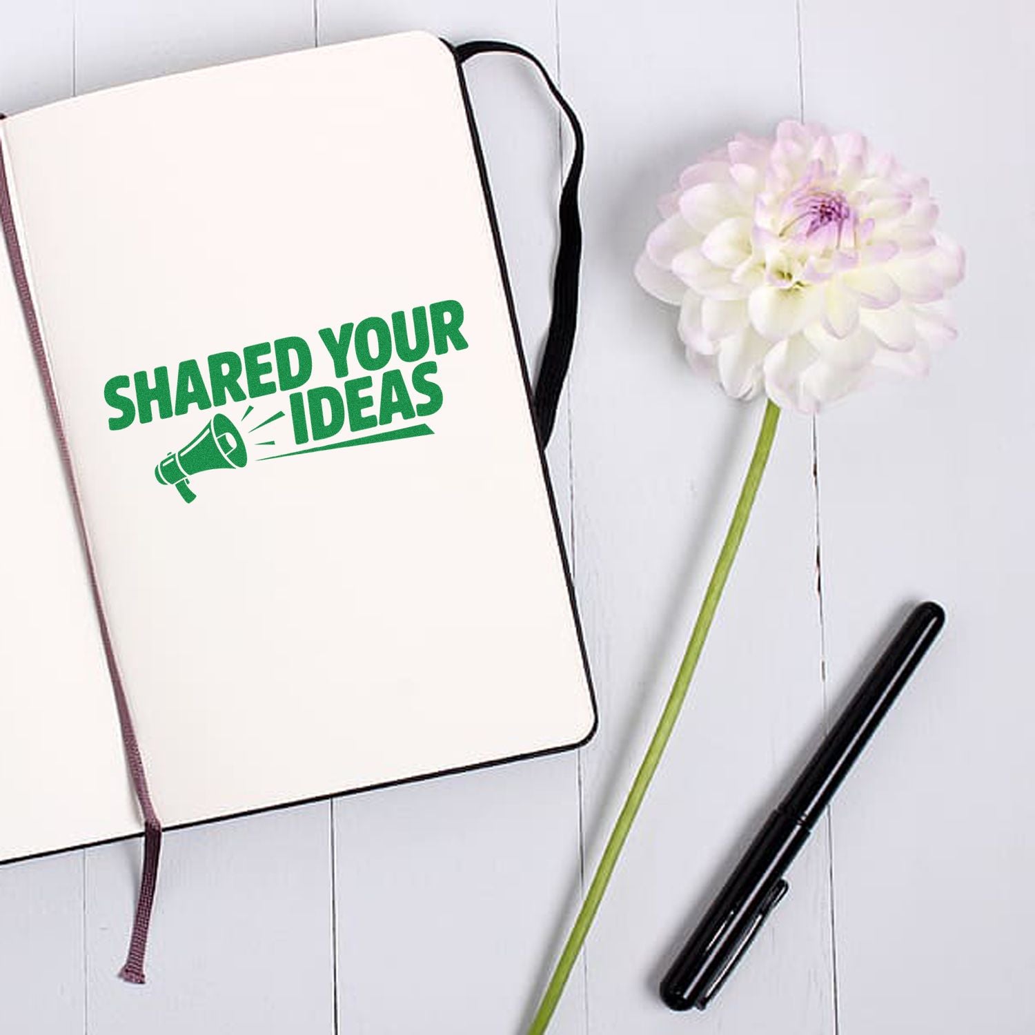 Custom rubber stamp design reading Shared Your Ideas with megaphone icon on notebook, ideal for branding and creative messaging.