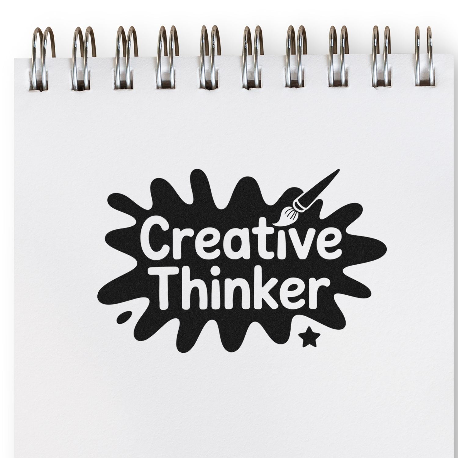 Creative Thinker rubber stamp design on a spiral notebook page, featuring a paintbrush icon for artists and creative planners.
