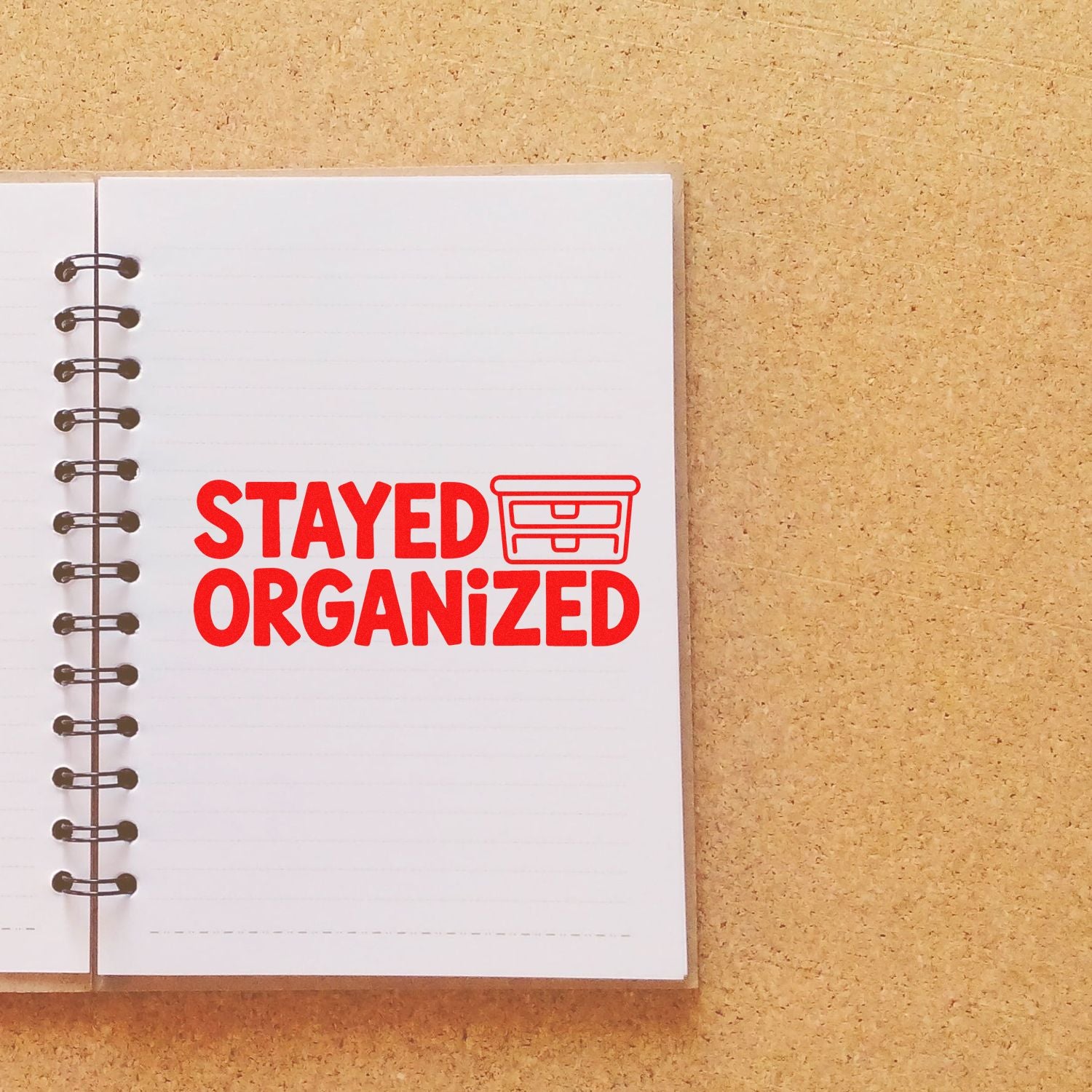 Red Stayed Organized rubber stamp on a notebook page for office, planner, and filing organization.