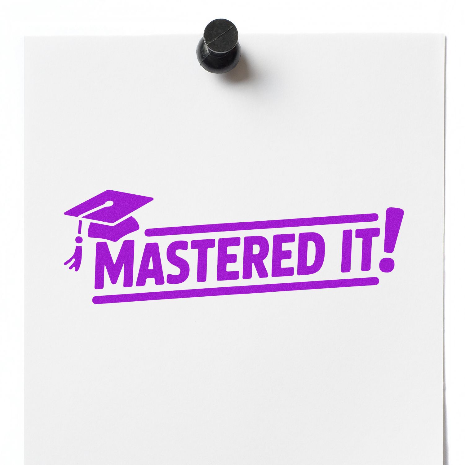 Rubber stamp impression reading Mastered It! with graduation cap icon, perfect for student achievement and reward marking.