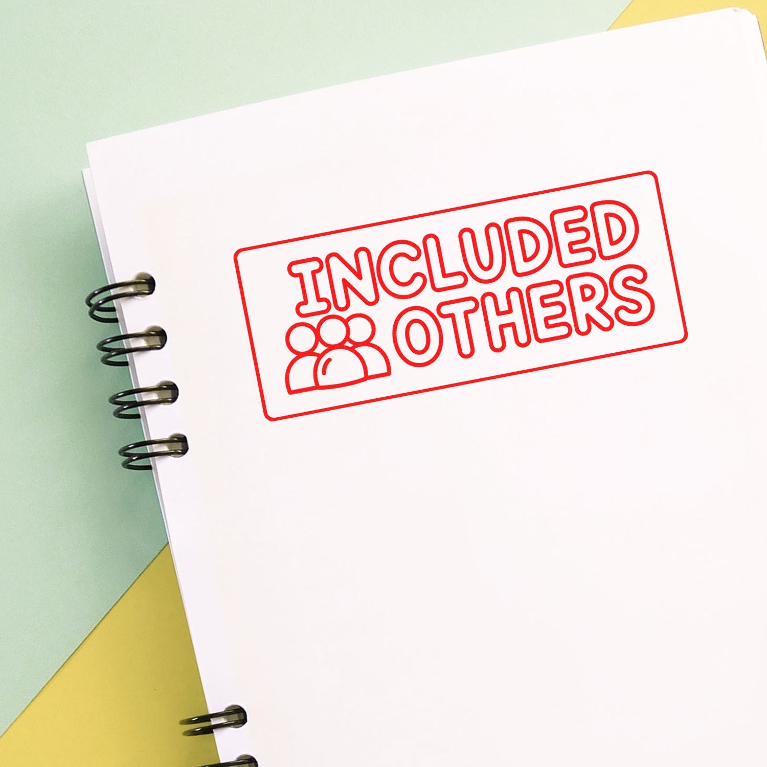 Red rubber stamp reading Included Others on notebook paper, perfect for inclusive business branding.