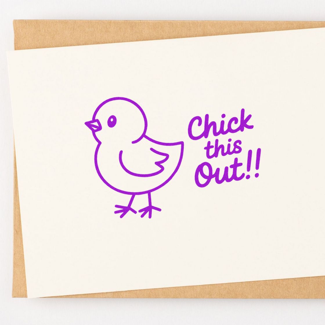 Purple chick rubber stamp design with Chick this out!! pun on a blank greeting card mockup.
