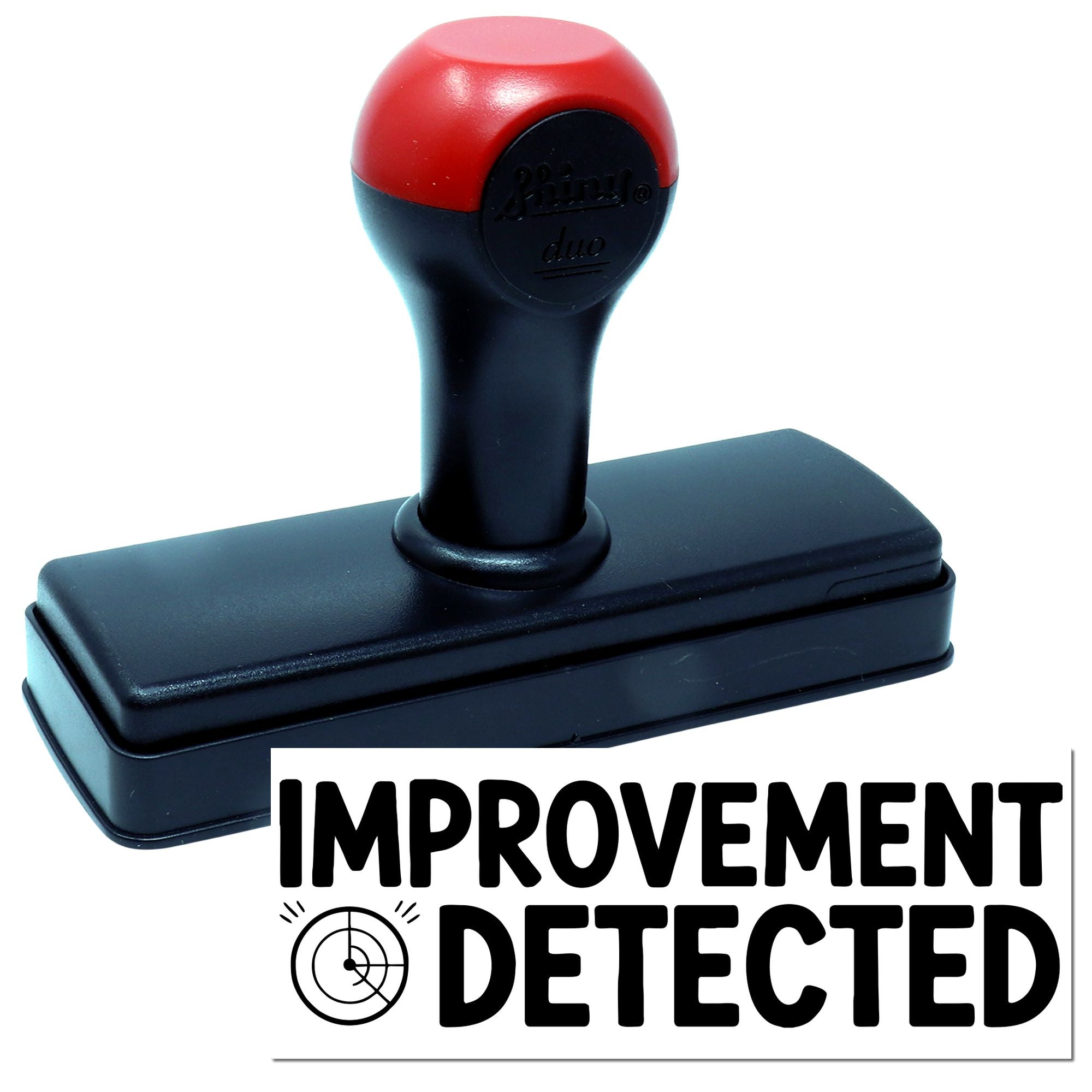 Self-inking rubber stamp with Improvement Detected imprint for quality control and review approval.