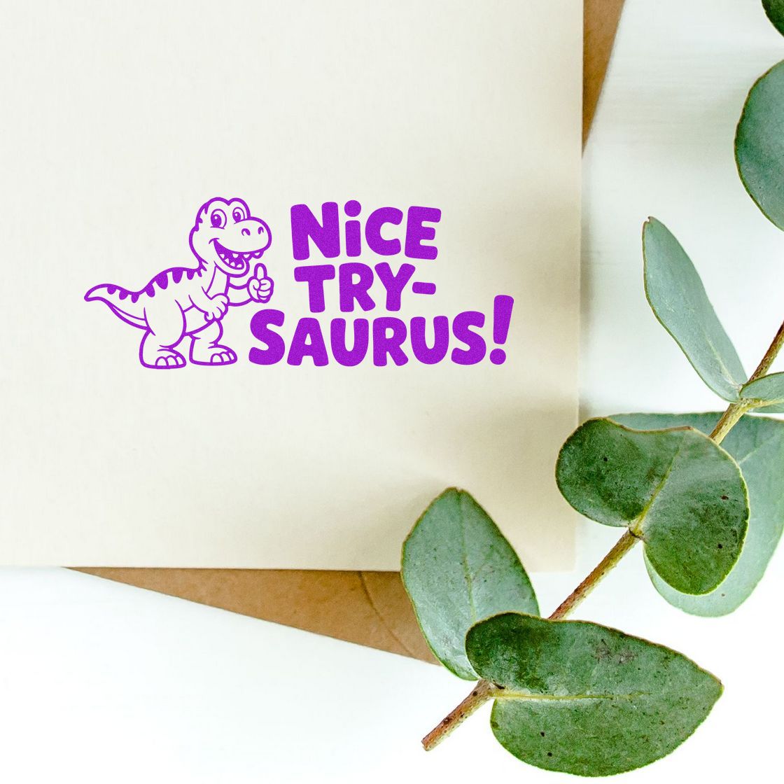 Playful dinosaur rubber stamp with Nice Try-saurus! text for funny encouragement cards, journaling, and notes.