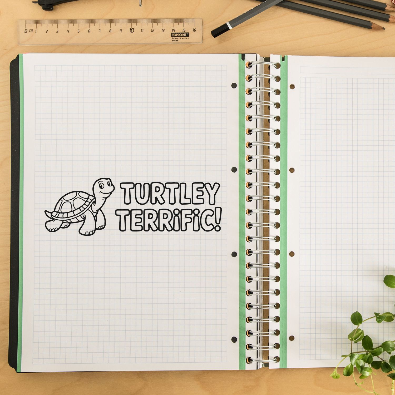 Turtle rubber stamp impression reading Turtley Terrific! in a notebook for classroom crafts and planner pages.