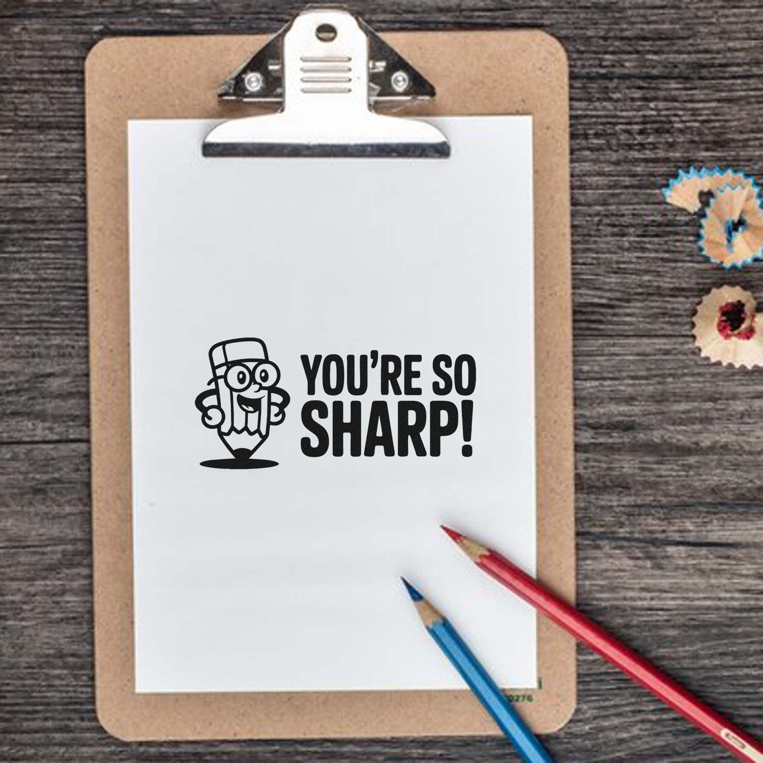 Humorous rubber stamp design with Youre So Sharp! pencil graphic on clipboard for classroom or school rewards.