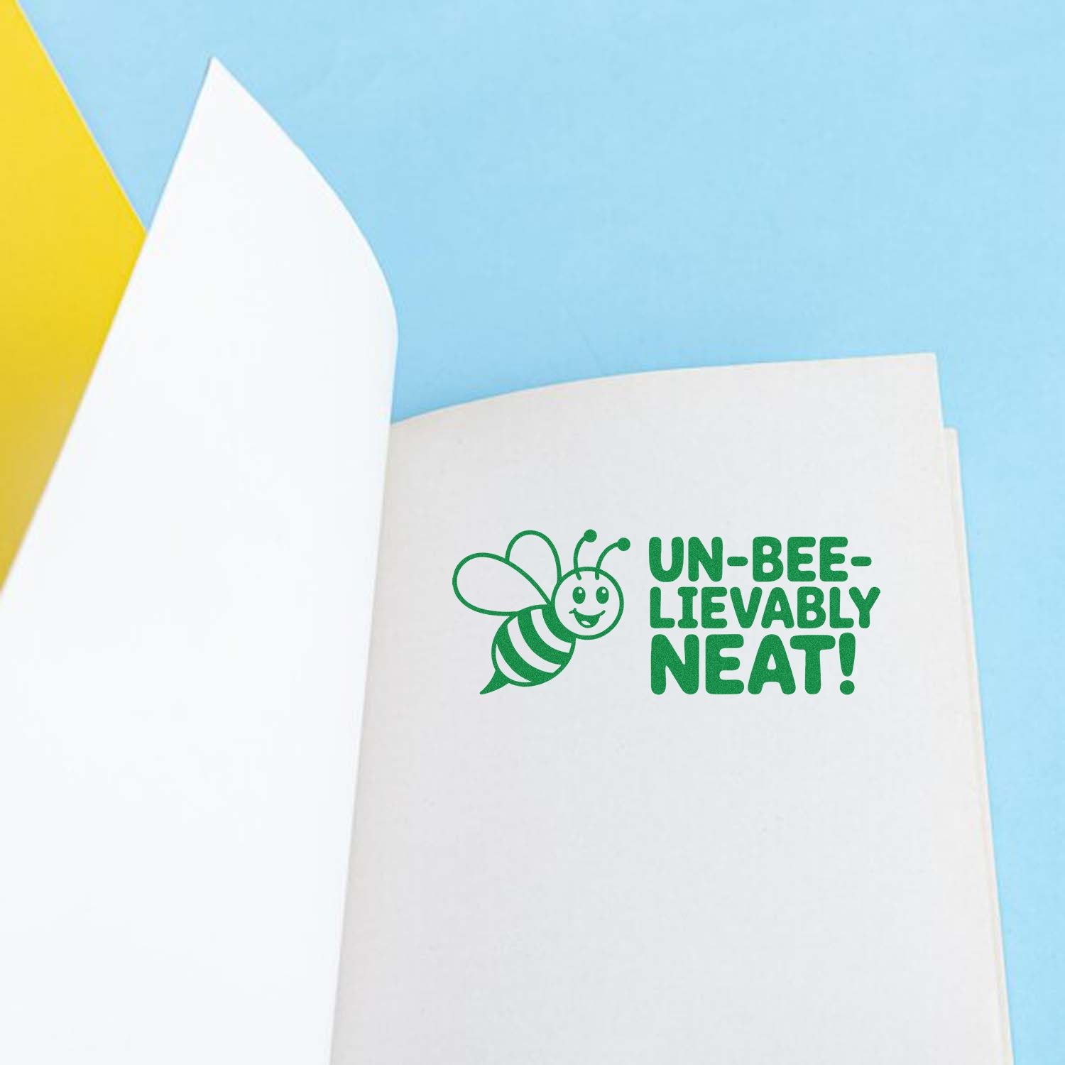 Un-bee-lievably neat bee rubber stamp on notebook page, perfect for crafting, journaling, and handmade cards.