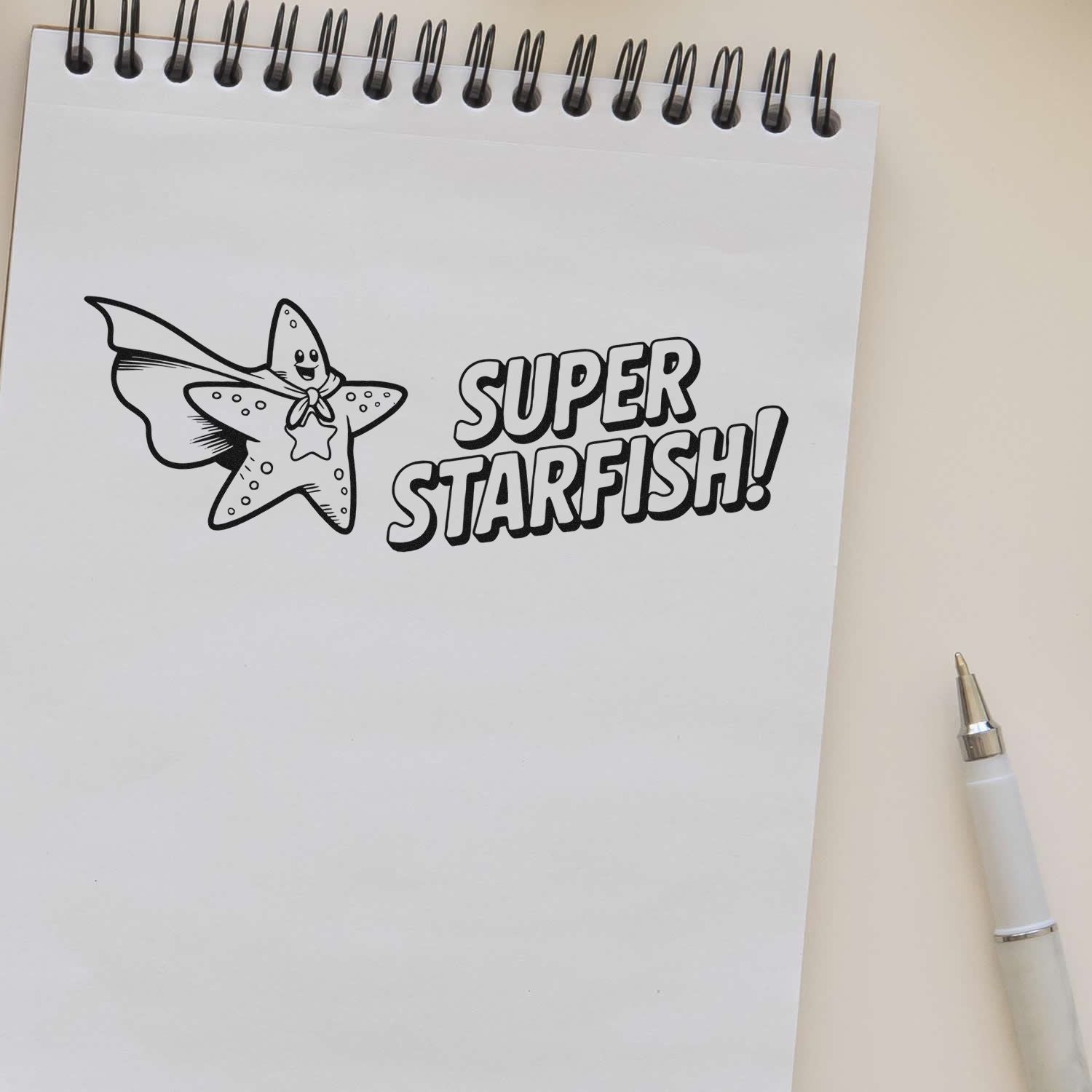 Custom rubber stamp impression of a Super Starfish superhero on a notepad, ideal for kids crafts and marine-themed projects.