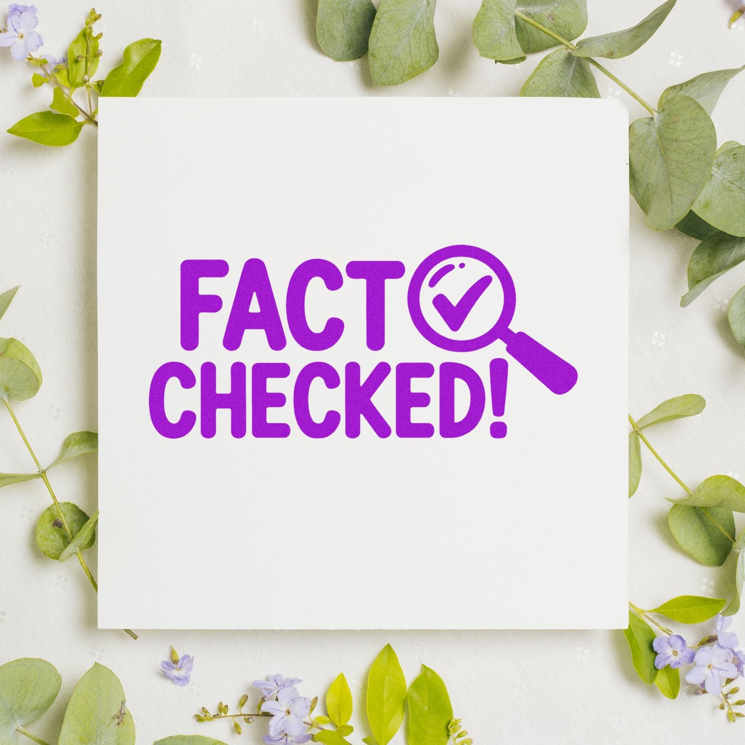 Fact Checked rubber stamp design with purple magnifying glass check mark on a white card.