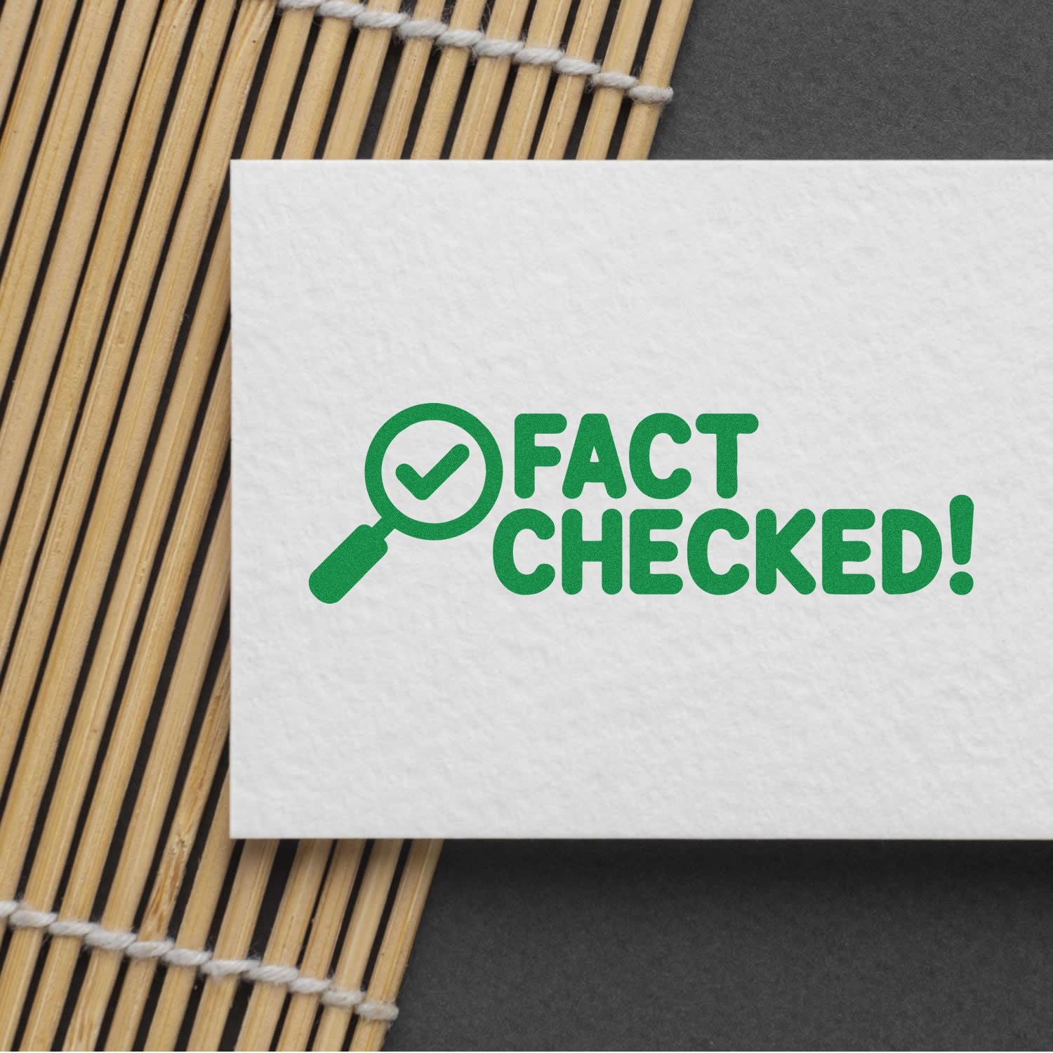 Green Fact Checked rubber stamp design with magnifying glass checkmark on white paper for quality control approvals.