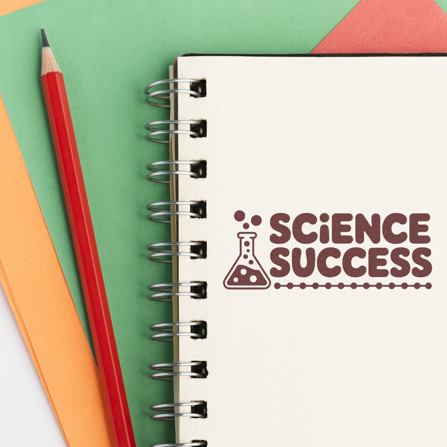 Science Success rubber stamp on a spiral notebook, perfect for classroom rewards, teacher feedback, and science lessons.