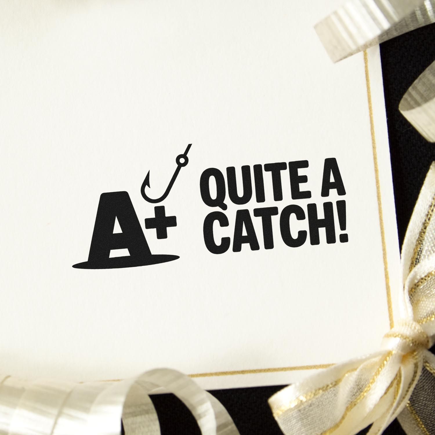 Custom rubber stamp reading A+ Quite a Catch! with fishing hook icon, ideal for teacher rewards and fishing-themed crafts.