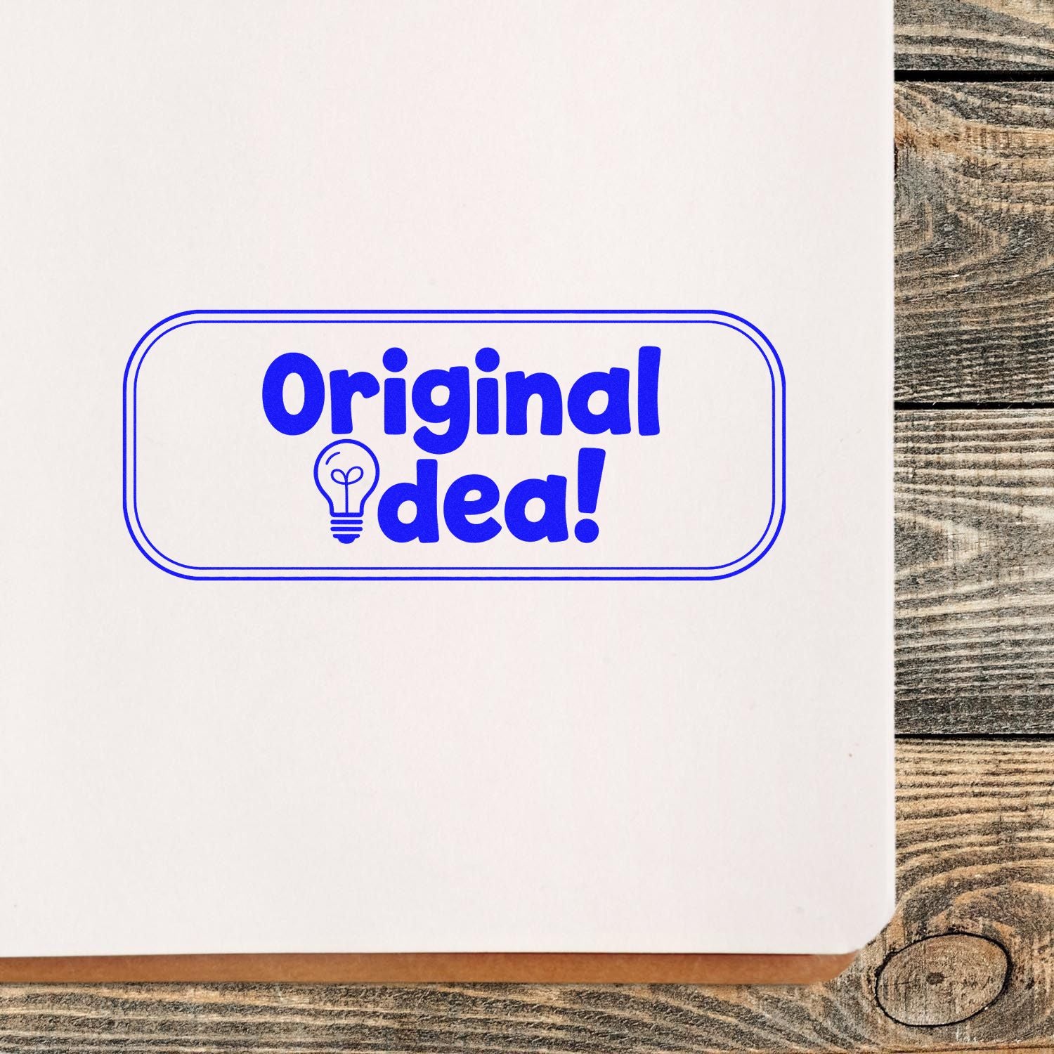 Blue Original Idea! rubber stamp impression with lightbulb icon on paper for creative branding and approval marking