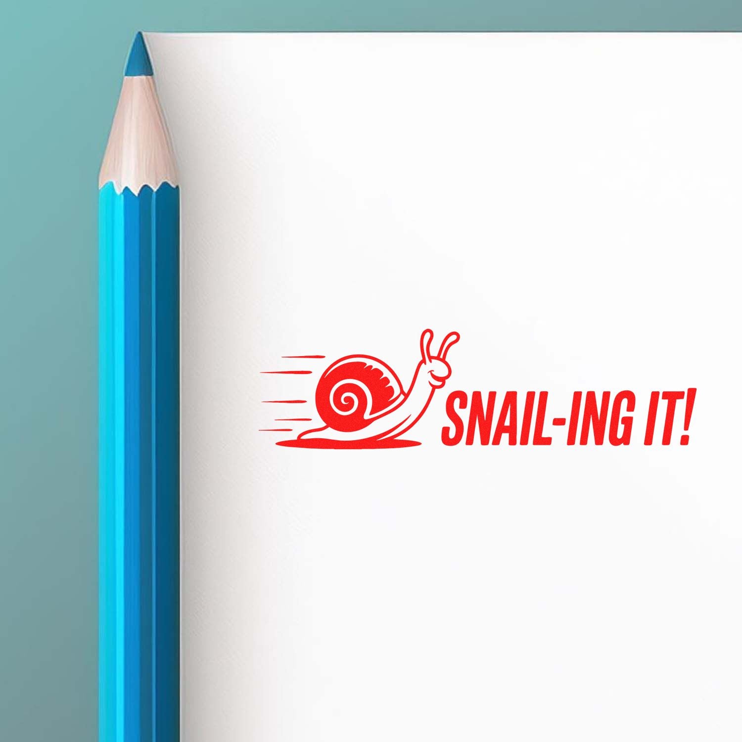 Custom rubber stamp design with snail Snail-ing it! slogan on paper beside a pencil for fun office branding.