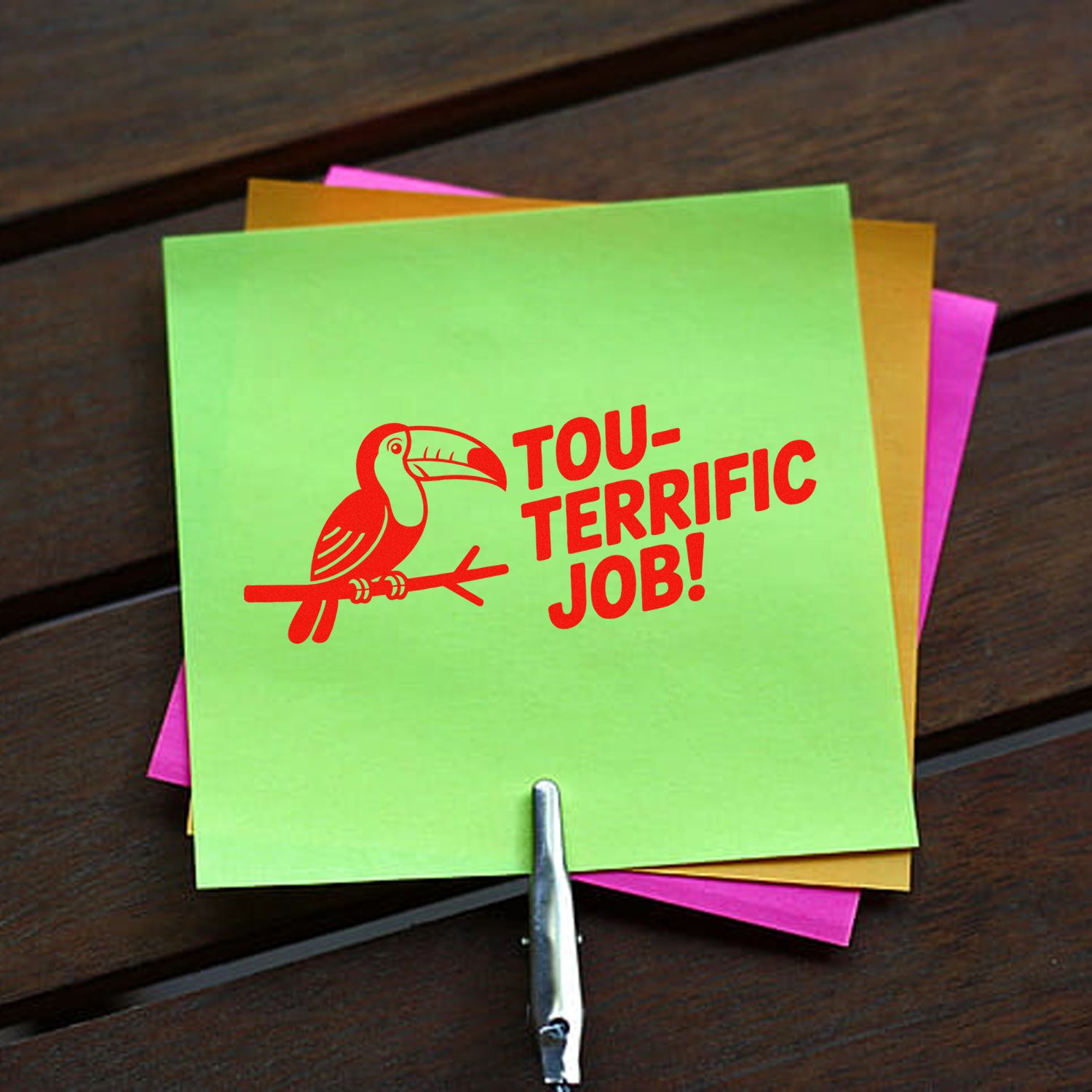Toucan rubber stamp saying Tou-terrific Job! on colorful sticky notes, ideal for teacher rewards and office praise.