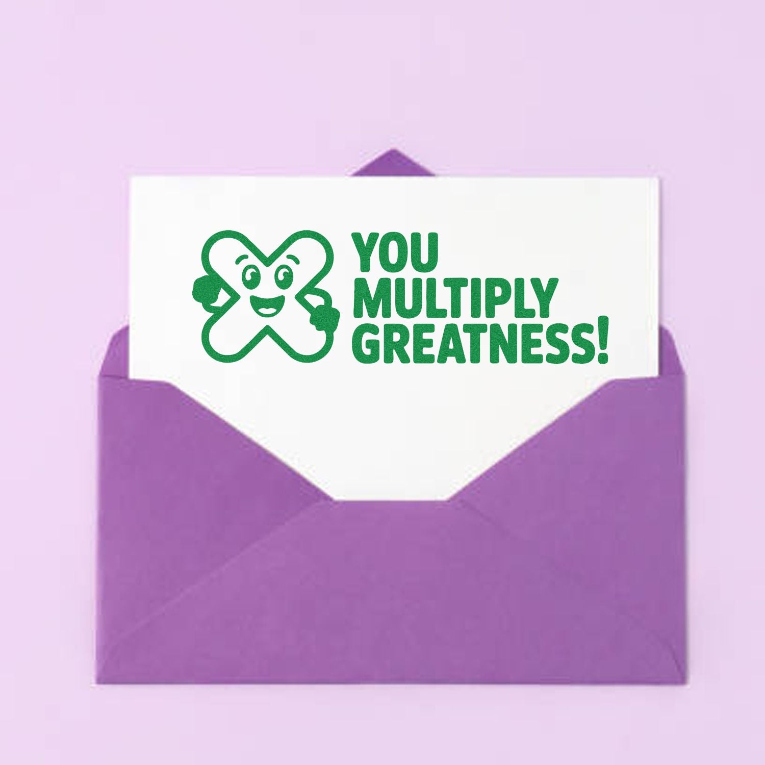 Motivational rubber stamp reading You Multiply Greatness! on a card in a purple envelope.