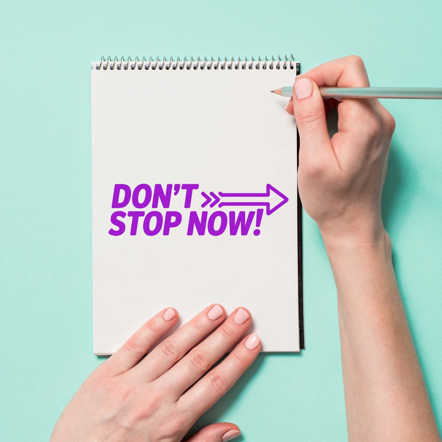 Dont Stop Now! motivational rubber stamp on notebook page, perfect for custom office and craft projects.