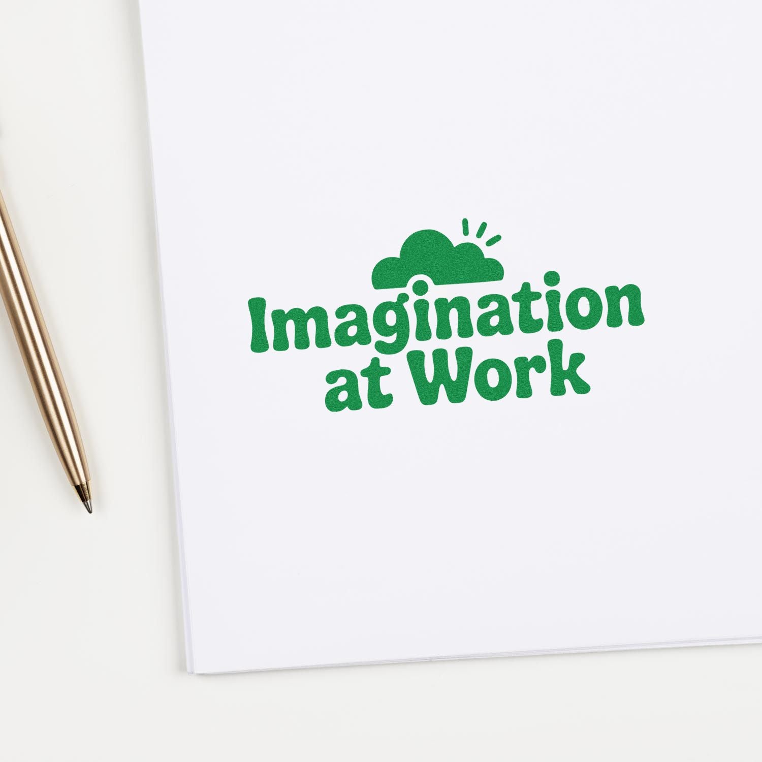 Green Imagination at Work custom rubber stamp on notebook, perfect for creative branding and stationery.