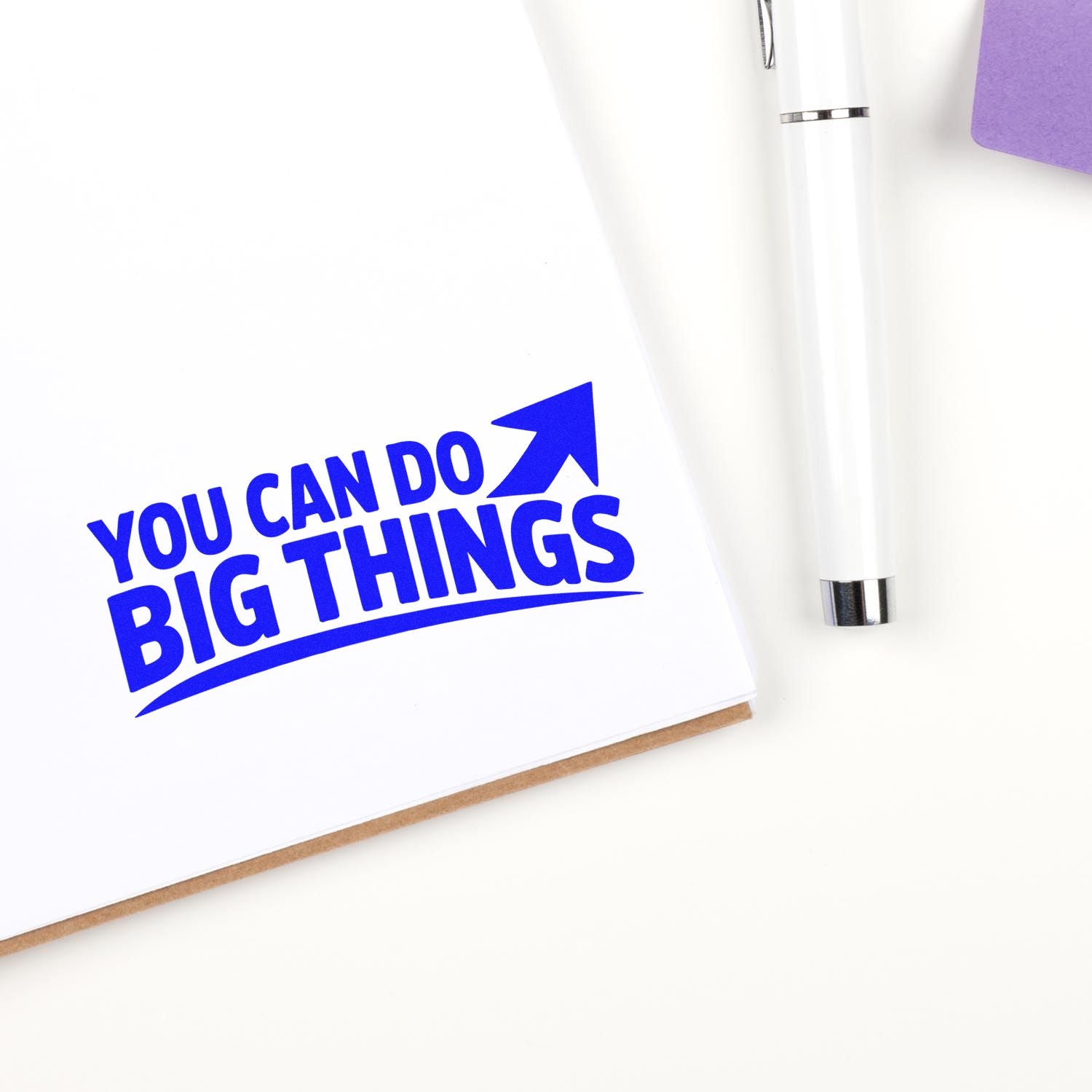 Motivational rubber stamp impression reading You Can Do Big Things with upward arrow on white paper.