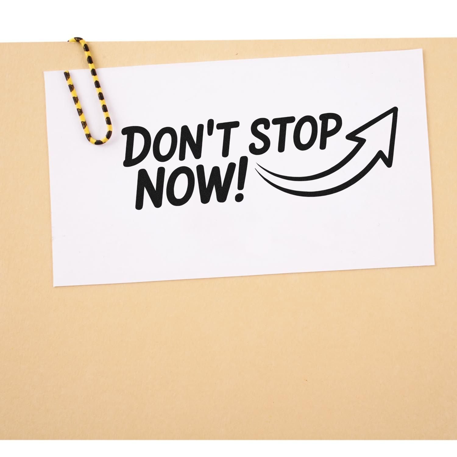 Motivational rubber stamp reading Dont Stop Now! with arrow, ideal for business, sales, and productivity messaging.