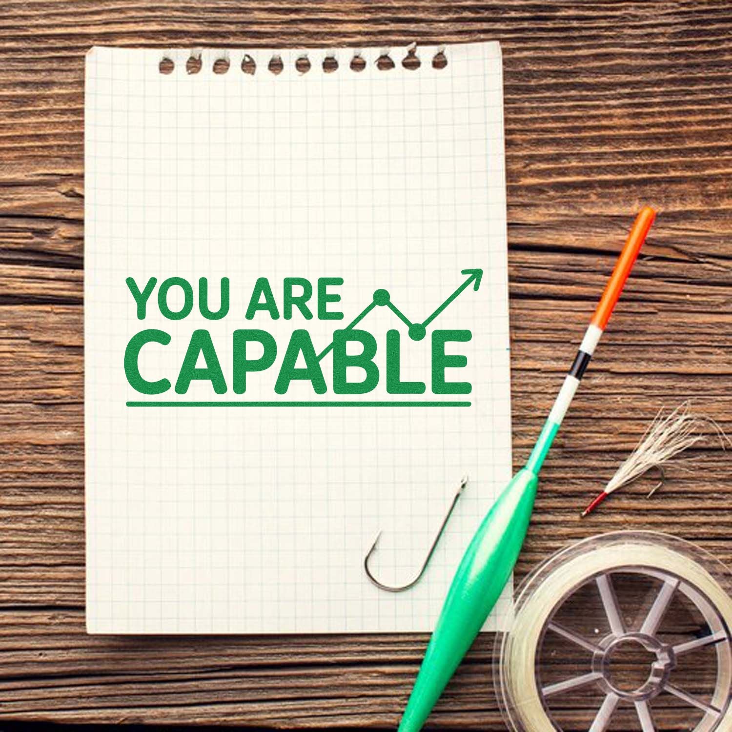 You Are Capable motivational rubber stamp design on notebook, ideal for inspiring handmade cards, planners, and office crafts.