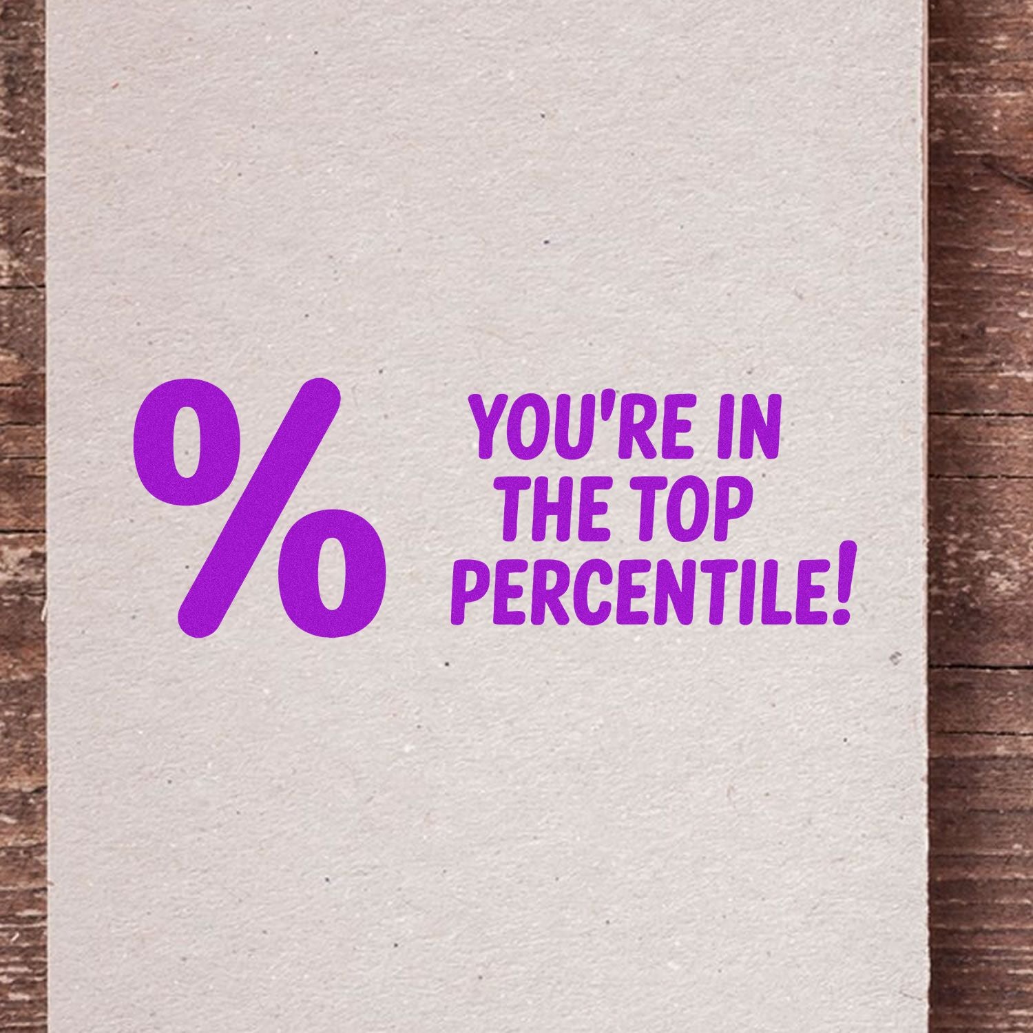 Purple rubber stamp design with large percent sign and Youre in the Top Percentile! for award or achievement marking.