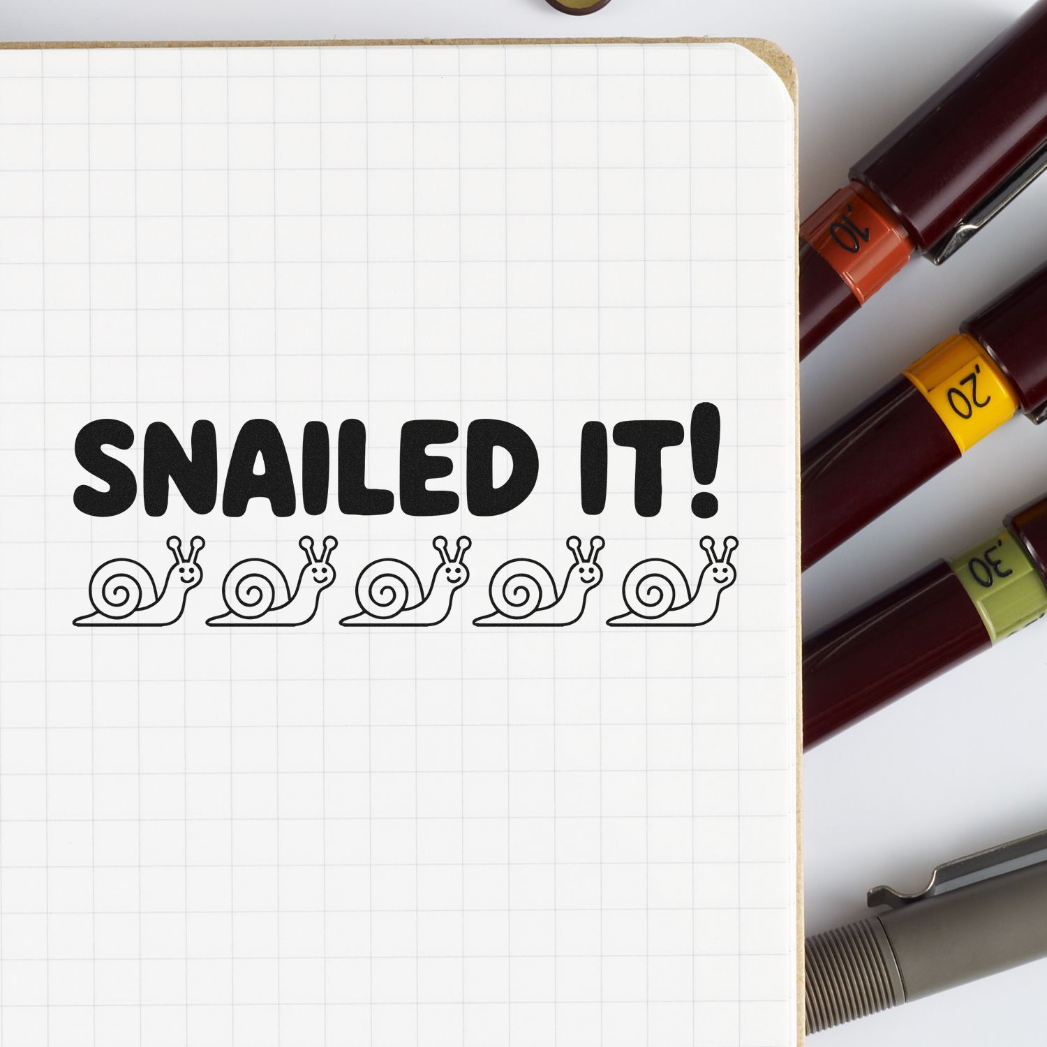 Snailed It rubber stamp design with playful snail icons for crafting, journaling, and card making.