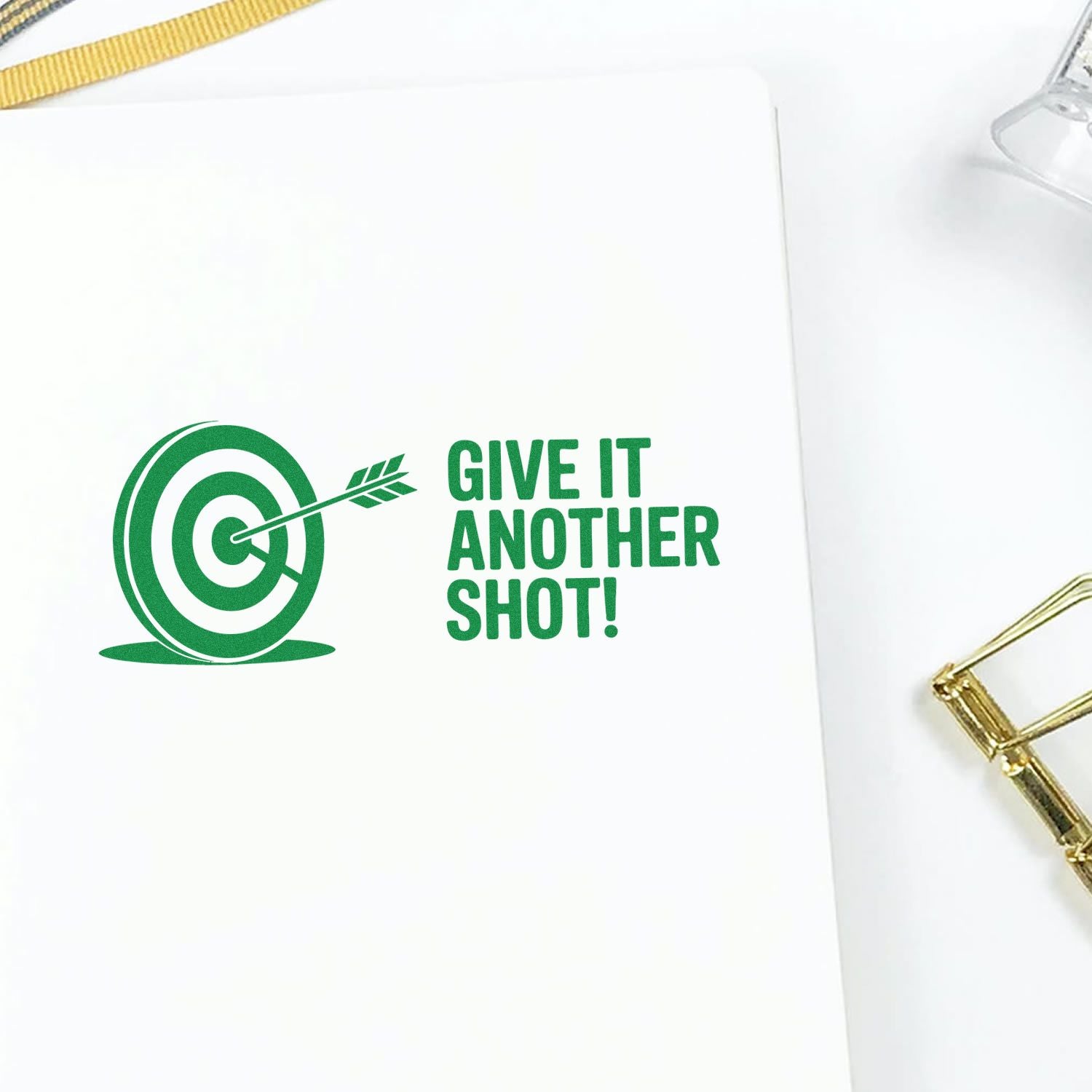 Green custom rubber stamp design with target and arrow, reading Give it another shot! for encouragement.