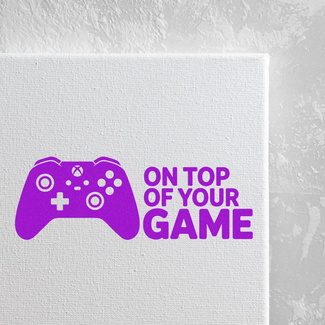 Custom gamer rubber stamp with purple game controller and On Top of Your Game slogan for gaming branding.