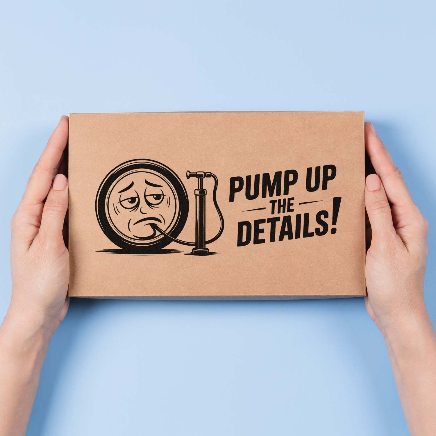 Hands holding kraft box with Pump Up the Details! tire and pump custom rubber stamp design for packaging.