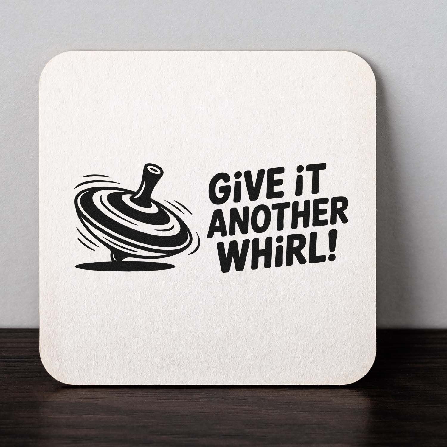 Rubber stamp design with spinning top and Give It Another Whirl! phrase for playful custom stamping projects.