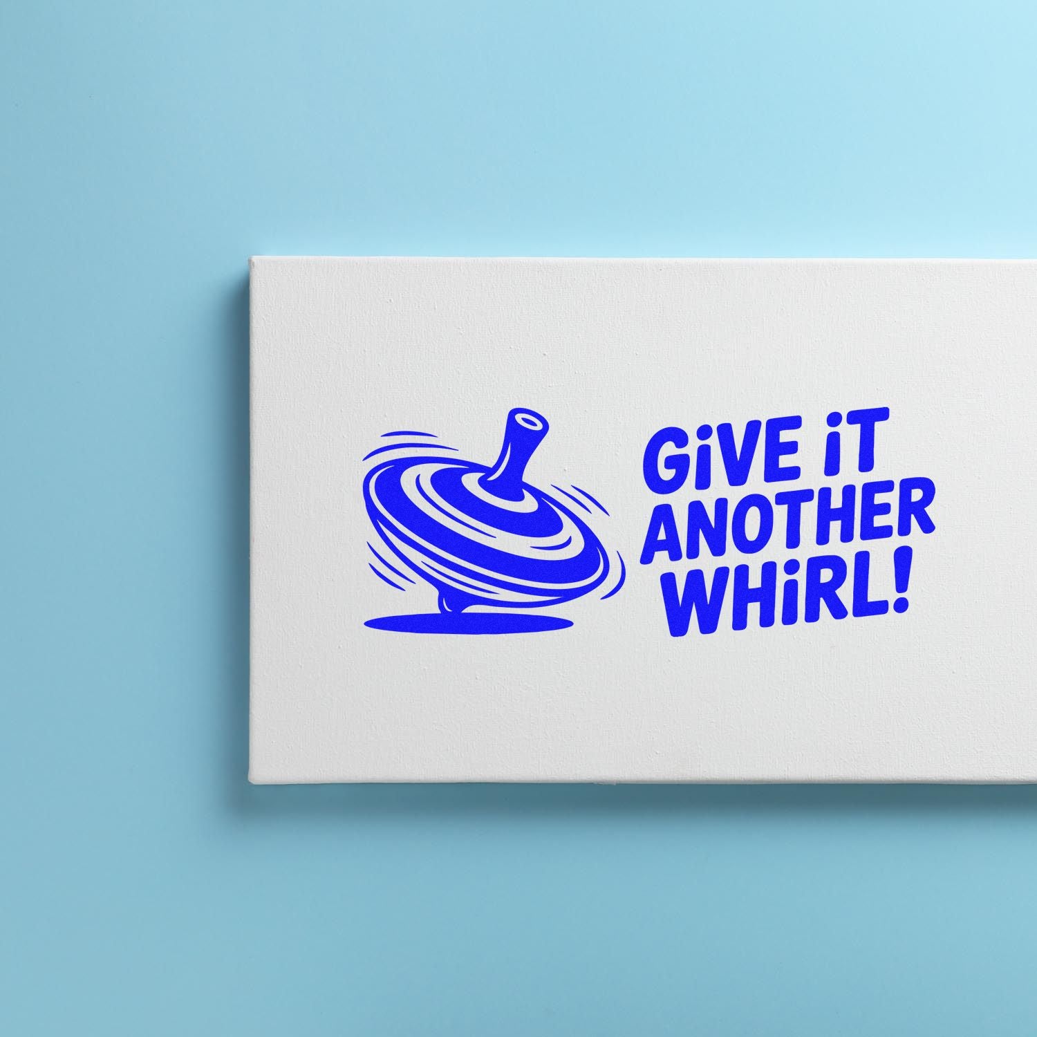 Blue custom rubber stamp design with spinning top icon and Give It Another Whirl! slogan on white.