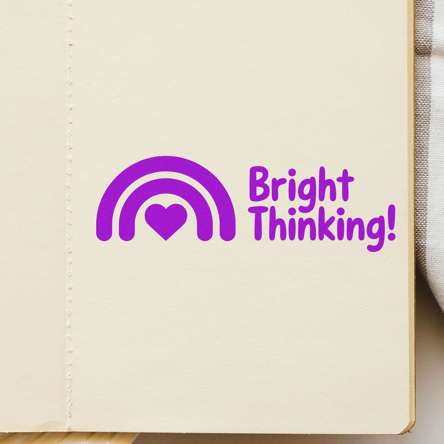 Bright Thinking! rainbow heart custom rubber stamp on notebook page for inspirational journaling and stationery.
