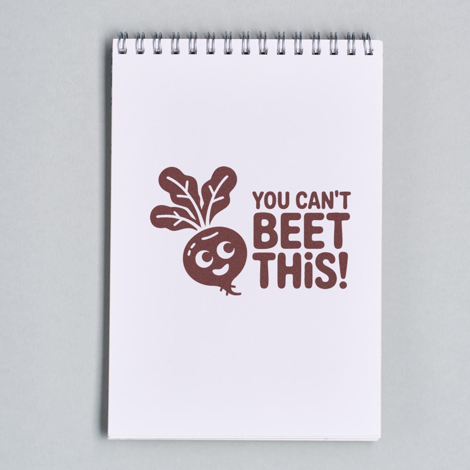 Funny beet pun rubber stamp reading You Cant Beet This! on a notebook page for playful stationery and craft projects.