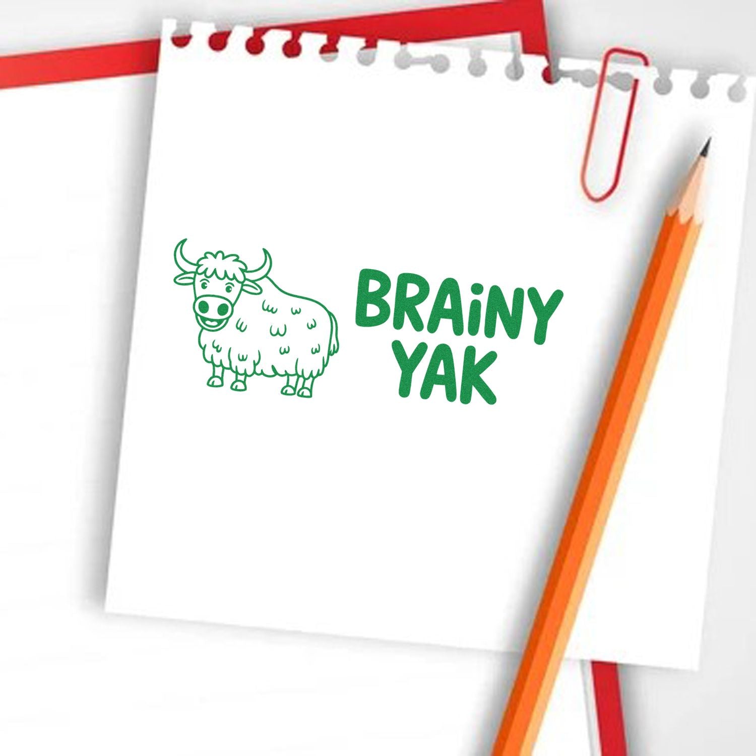 Brainy Yak custom rubber stamp design on notebook paper, ideal for playful stationery, classroom branding, and craft projects.