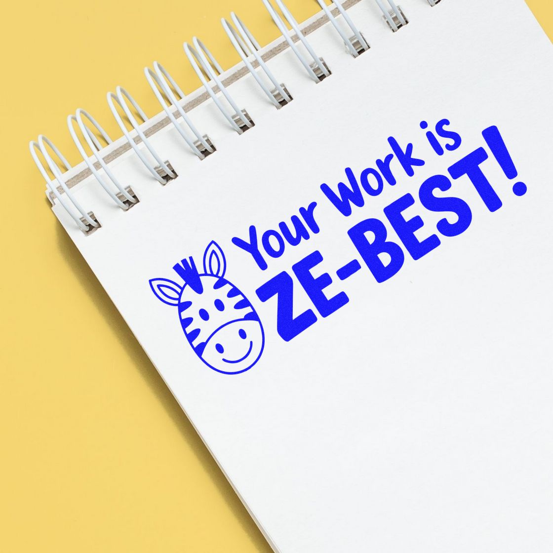Blue zebra-themed rubber stamp saying Your Work is ZEBEST! on a notebook, ideal for teachers, offices, and motivation.