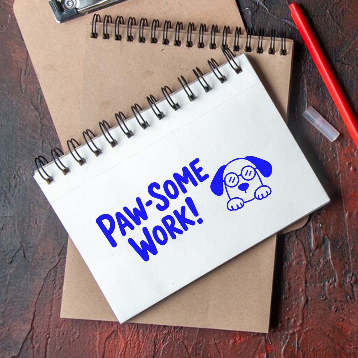 Dog-themed Paw-some Work! rubber stamp on spiral notebook for classroom rewards and pet lover stationery.