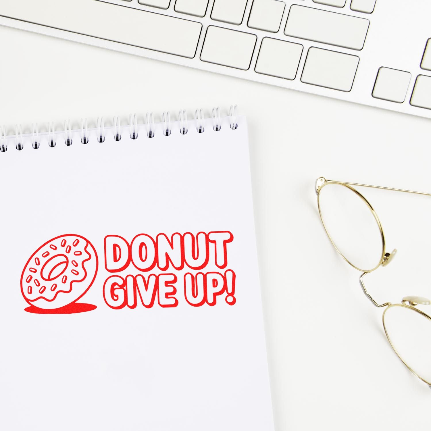 Donut Give Up custom rubber stamp design on notebook, a fun motivational office stamp for teachers, planners, and stationery.