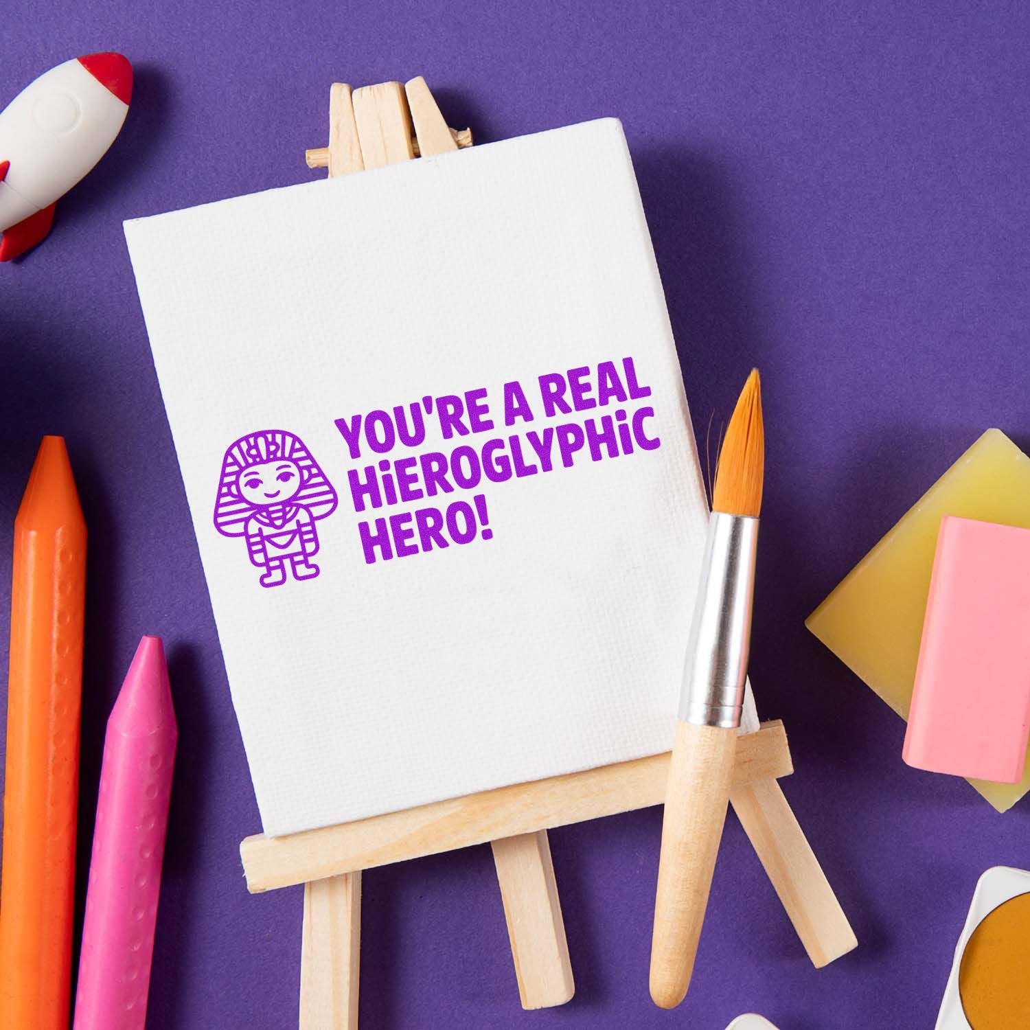 Egyptian-themed rubber stamp design with phrase Youre a real hieroglyphic hero! for classroom crafts and reward stamping.