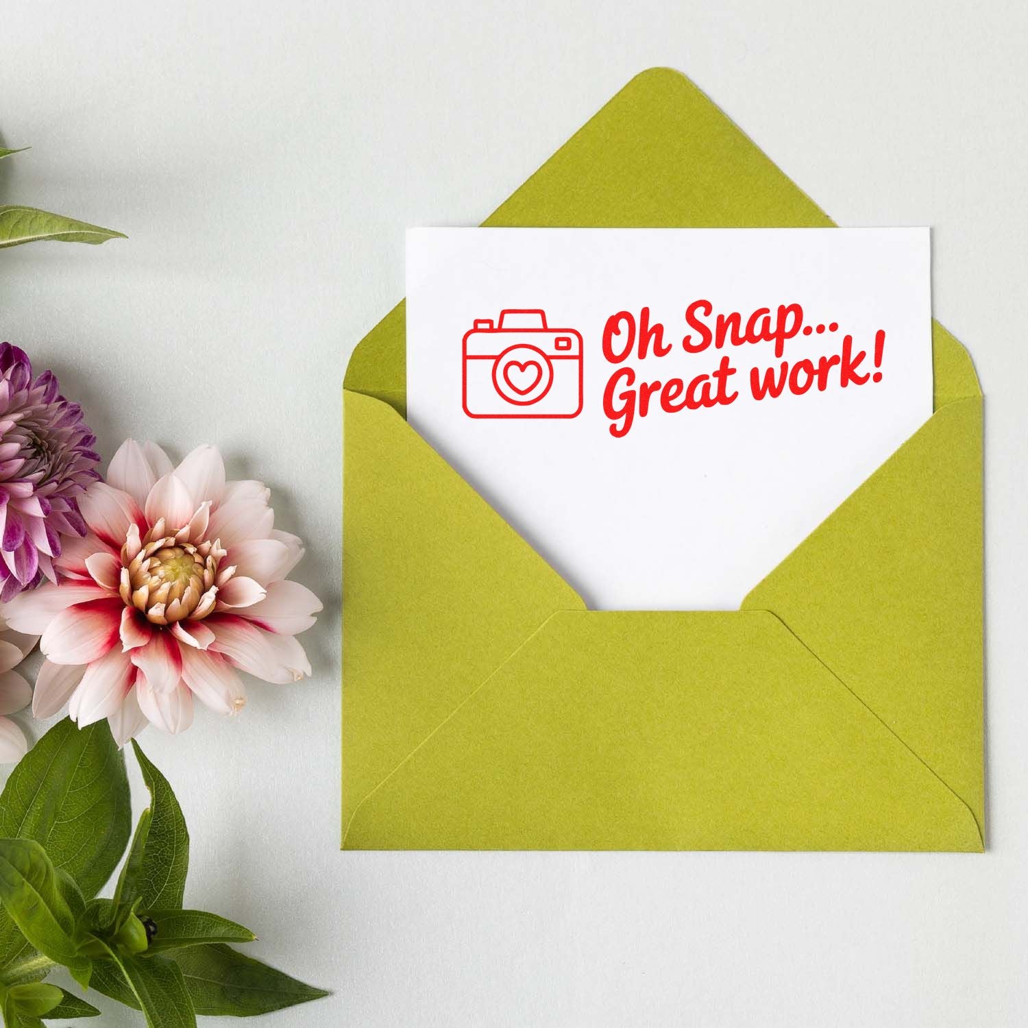 Photo-themed rubber stamp saying Oh Snap... Great work! on a greeting card in a green envelope with flowers.