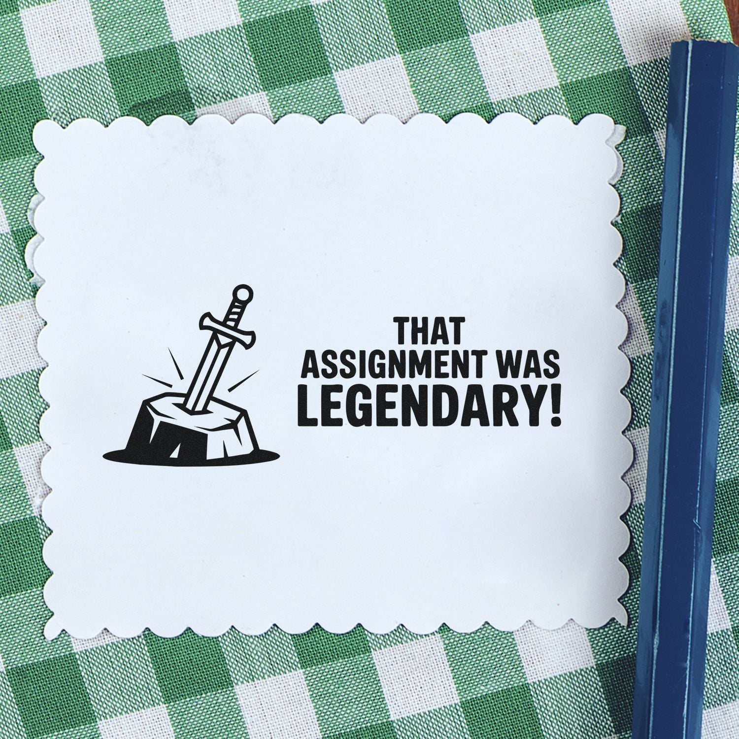 Legendary assignment rubber stamp with sword-in-stone graphic and bold teacher praise text on scalloped card.