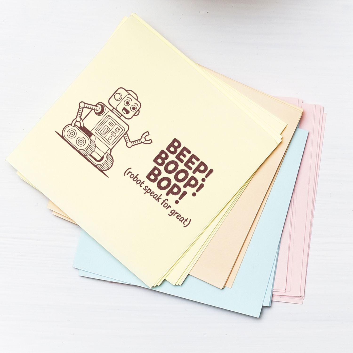 Robot-themed rubber stamp design reading Beep! Boop! Boop! on pastel cardstock for custom stationery, crafts, and packaging.