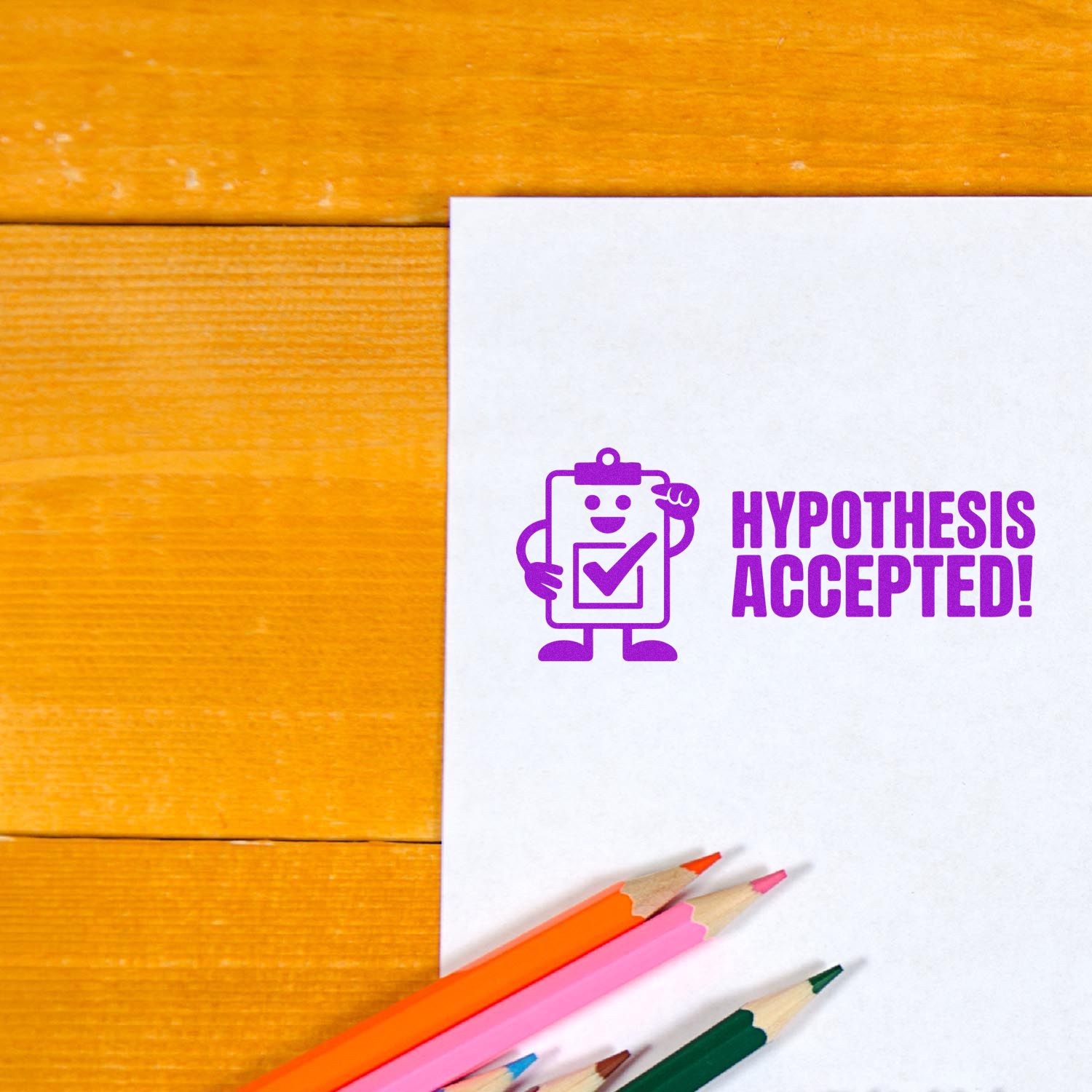 Purple Hypothesis Accepted rubber stamp on white paper with colored pencils, for science classroom grading.