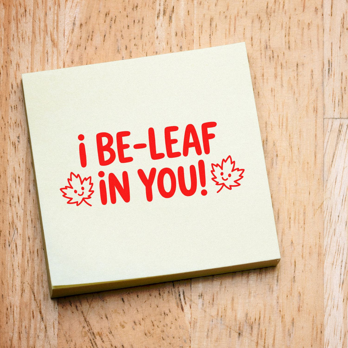 Rubber stamp design reading I be-leaf in you! with smiling leaf icons, perfect for encouragement cards and crafts.