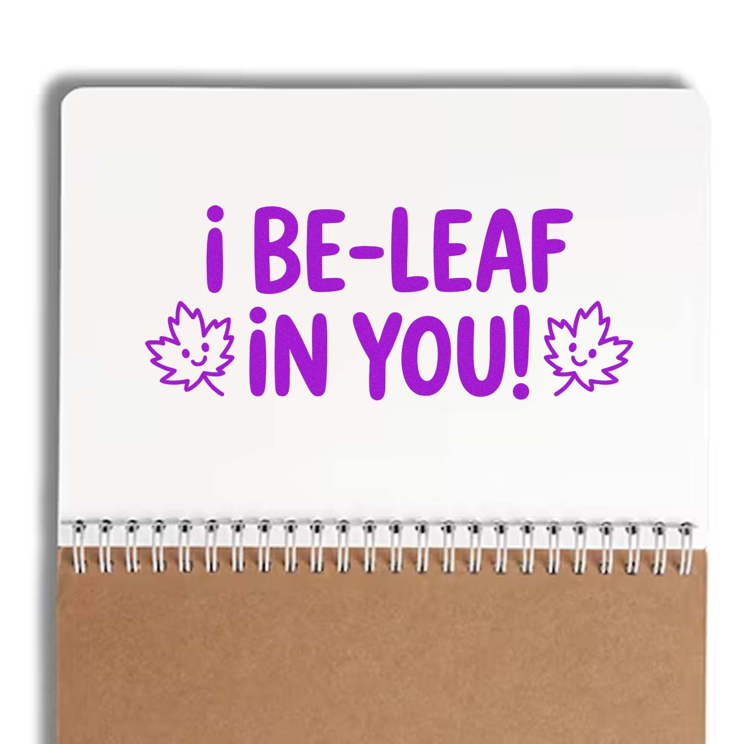 Purple rubber stamp design reading I BE-LEAF IN YOU! with smiling leaves, ideal for spring cards, teacher gifts, and crafts.