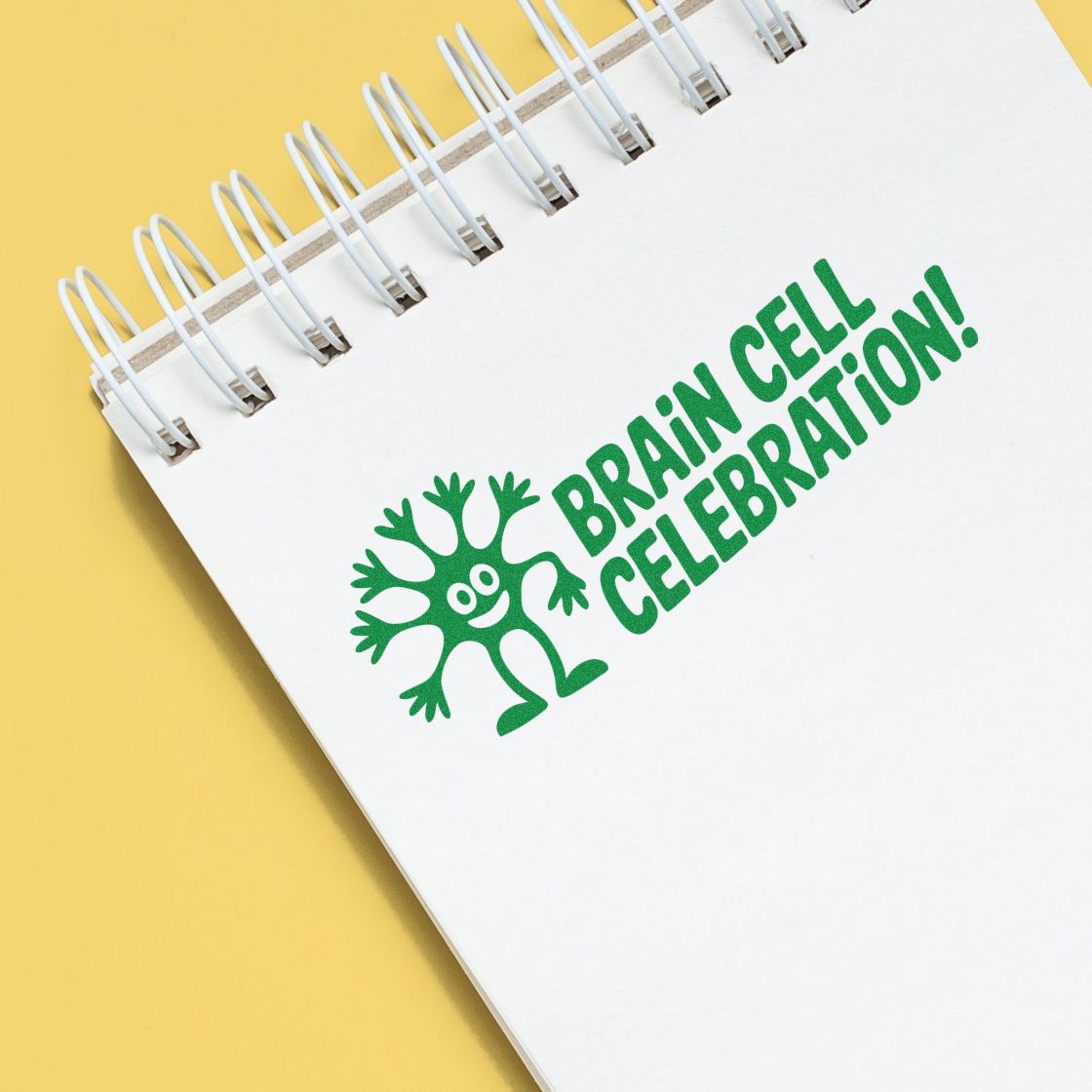 Brain Cell Celebration custom rubber stamp impression with neuron graphic on a notebook for science-themed stationery.