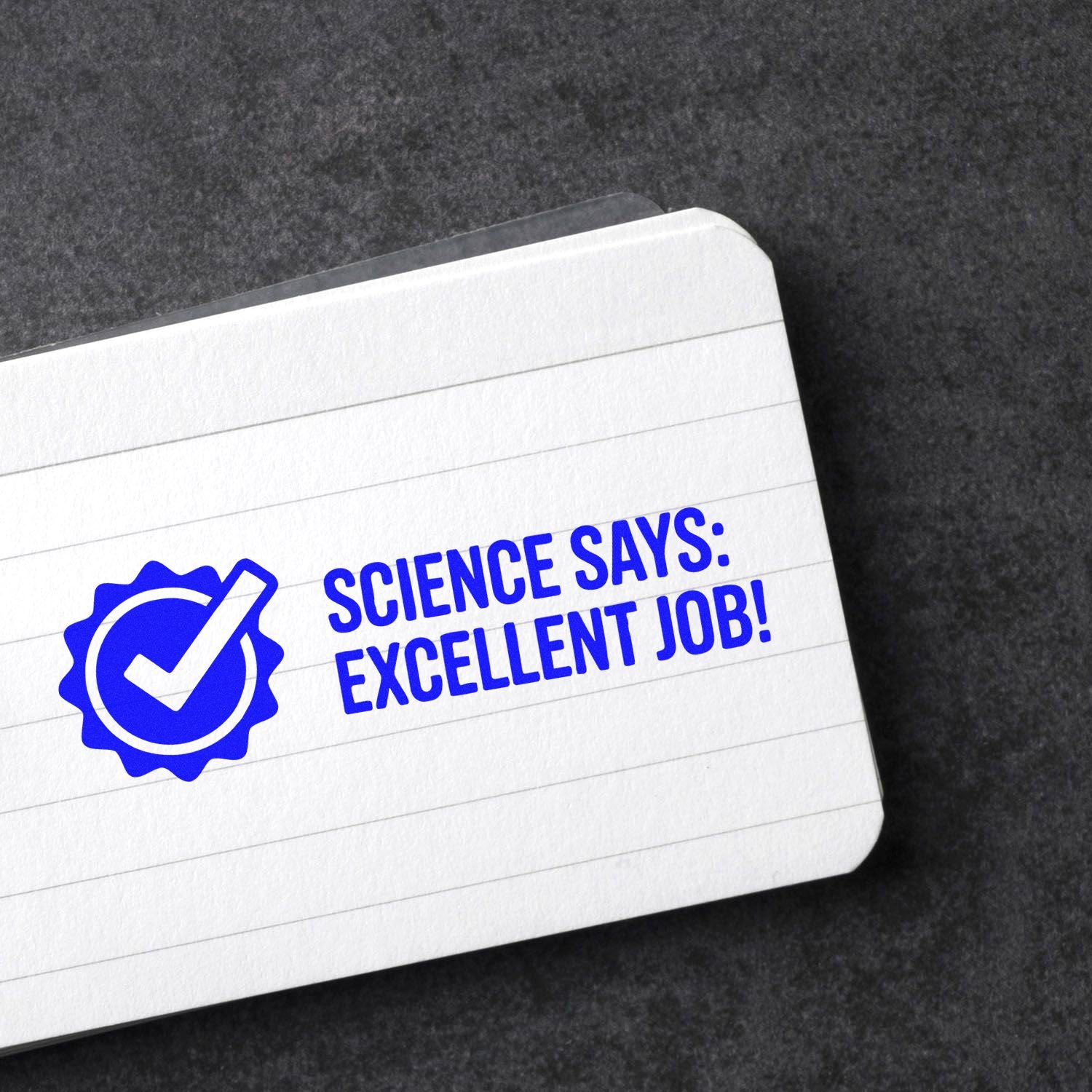 Blue custom rubber stamp reading Science Says: Excellent Job! on notebook paper, ideal for teacher grading and student rewards.