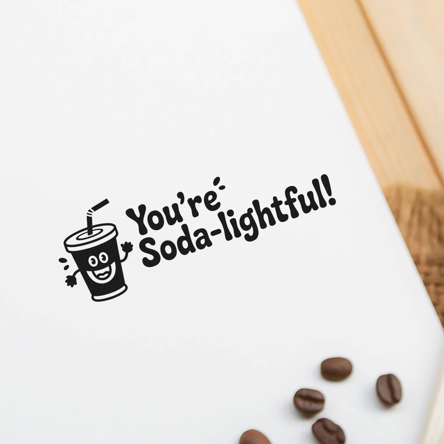 Custom rubber stamp impression with smiling soda cup and Youre Soda-lightful! text for fun packaging and craft projects.