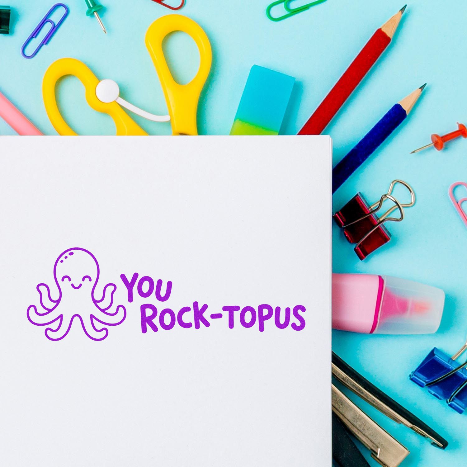 Cute octopus rubber stamp with You Rock-topus on a blank card, surrounded by colorful school supplies, ideal for teacher rewards.